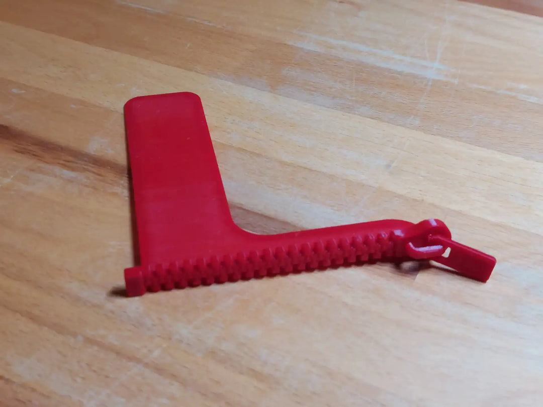 Boekenlegger Rits – speels design – kunststof – grijs, zwart, wit, roze, blauw & rood