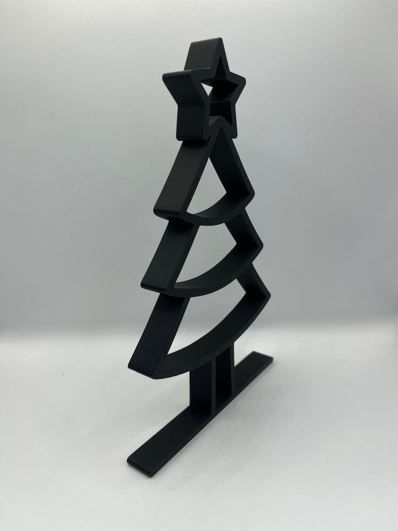 Zwart minimalistisch kerstboomornament in schuin zijaanzicht met moderne vormgeving.